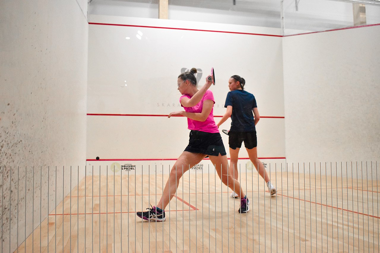 Two girls playing squash