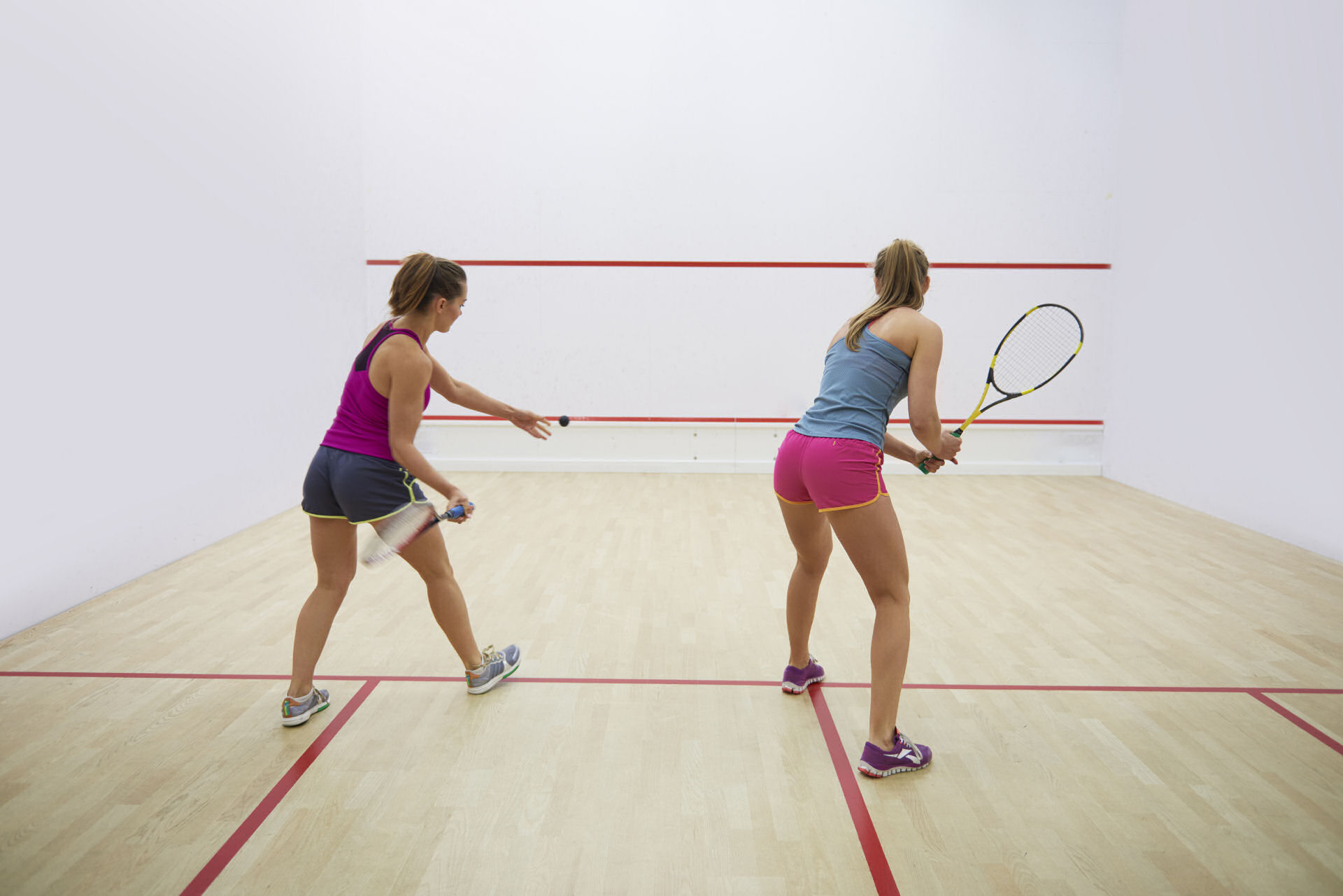Active young people playing squash